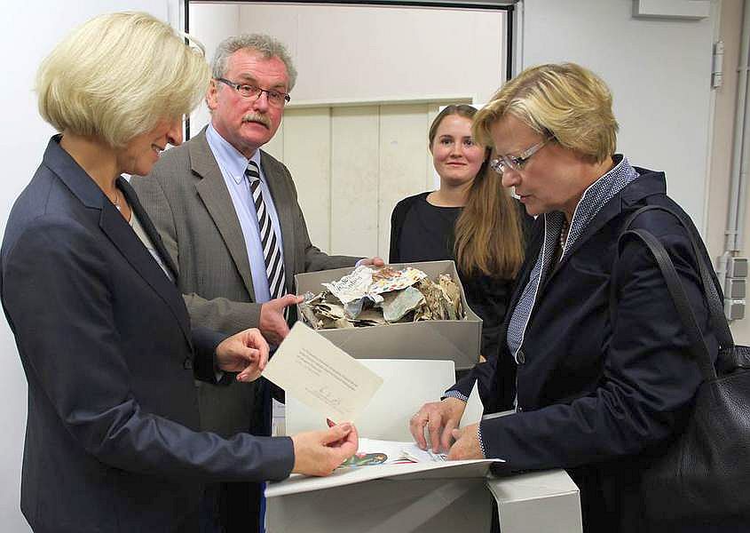 Stadträtin Babette Bammann, Stadtarchivar Ludwig Burwitz, Lisa Arnold von der Projektgruppe "Asylarchiv" und Dr. Bettina Schmidt-Czaia begutachteten den Inhalt einiger Archiv-Kartons.